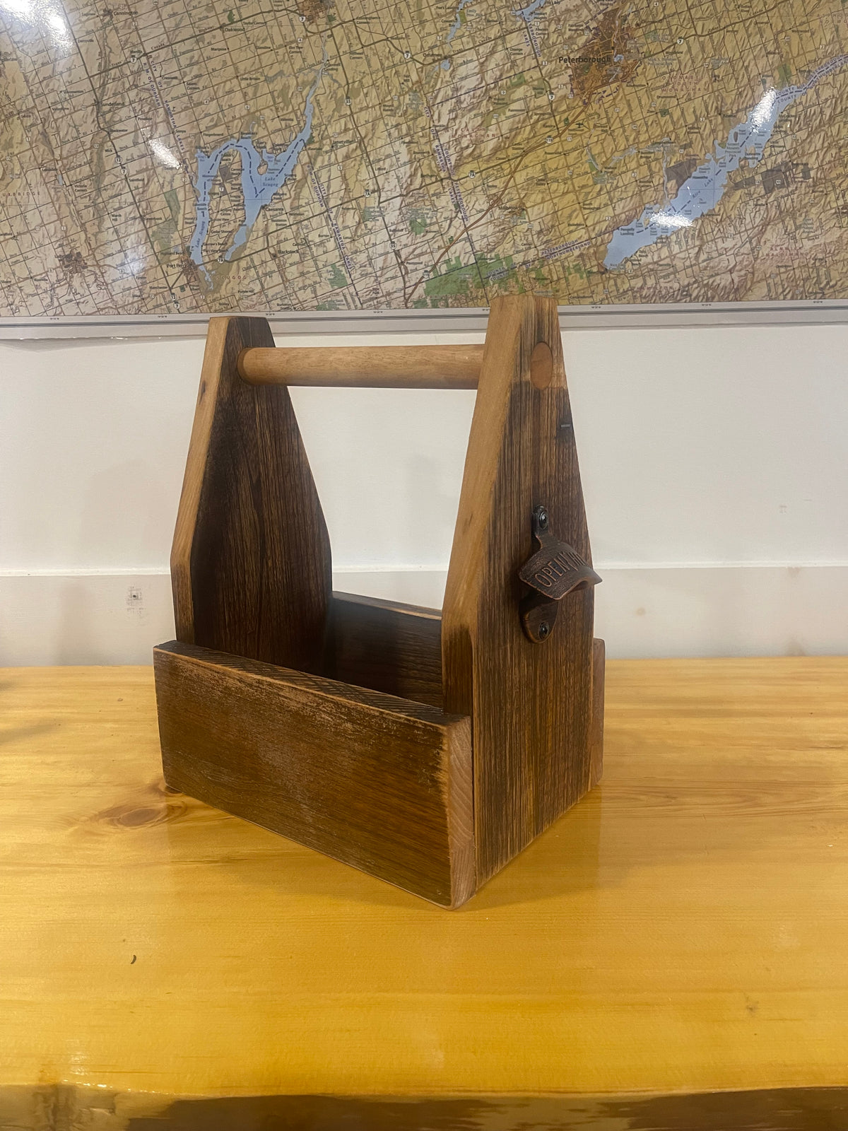 Empty barnwood six-pack caddy built from this plan, with dowel handle and bottle opener
